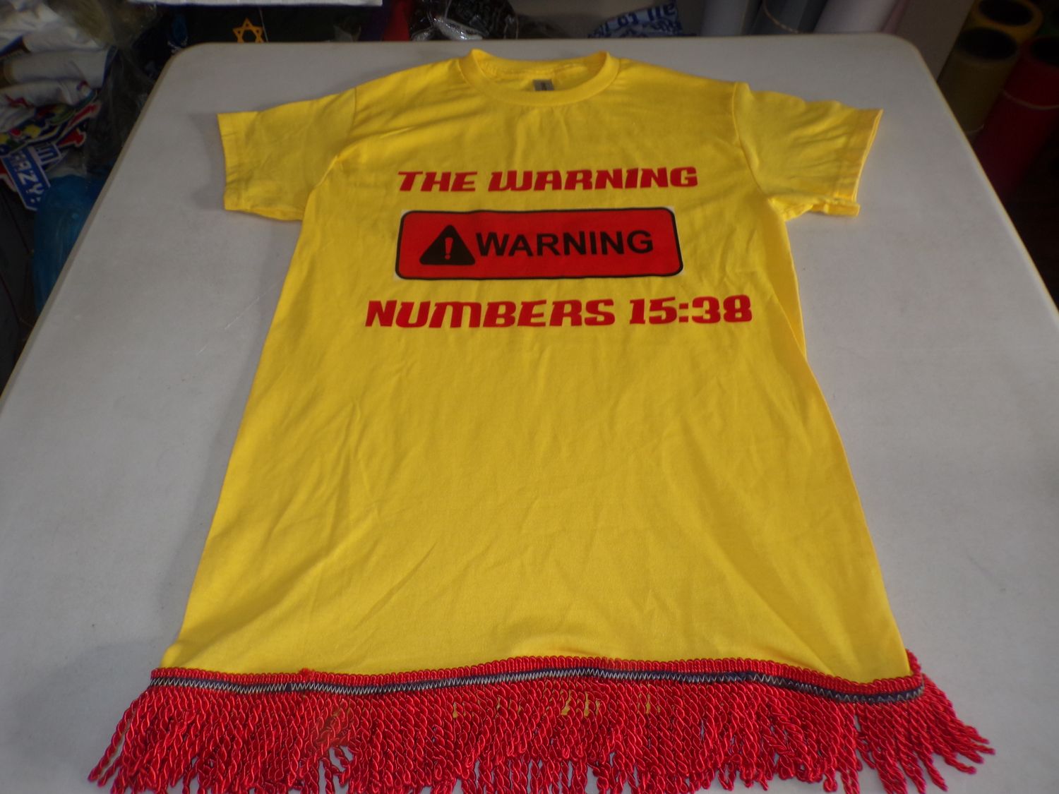 The Warning Numbers 15:38 Yellow Shirt Red Fringes