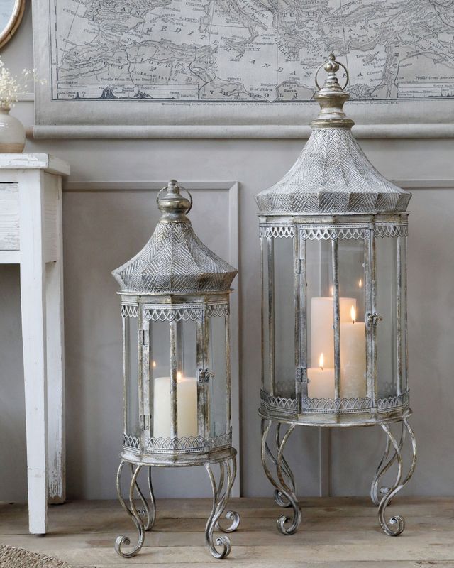 Stately home vibes exude from these stunning Vire Lanterns with flickering candles and arranged against a panelled grey wall