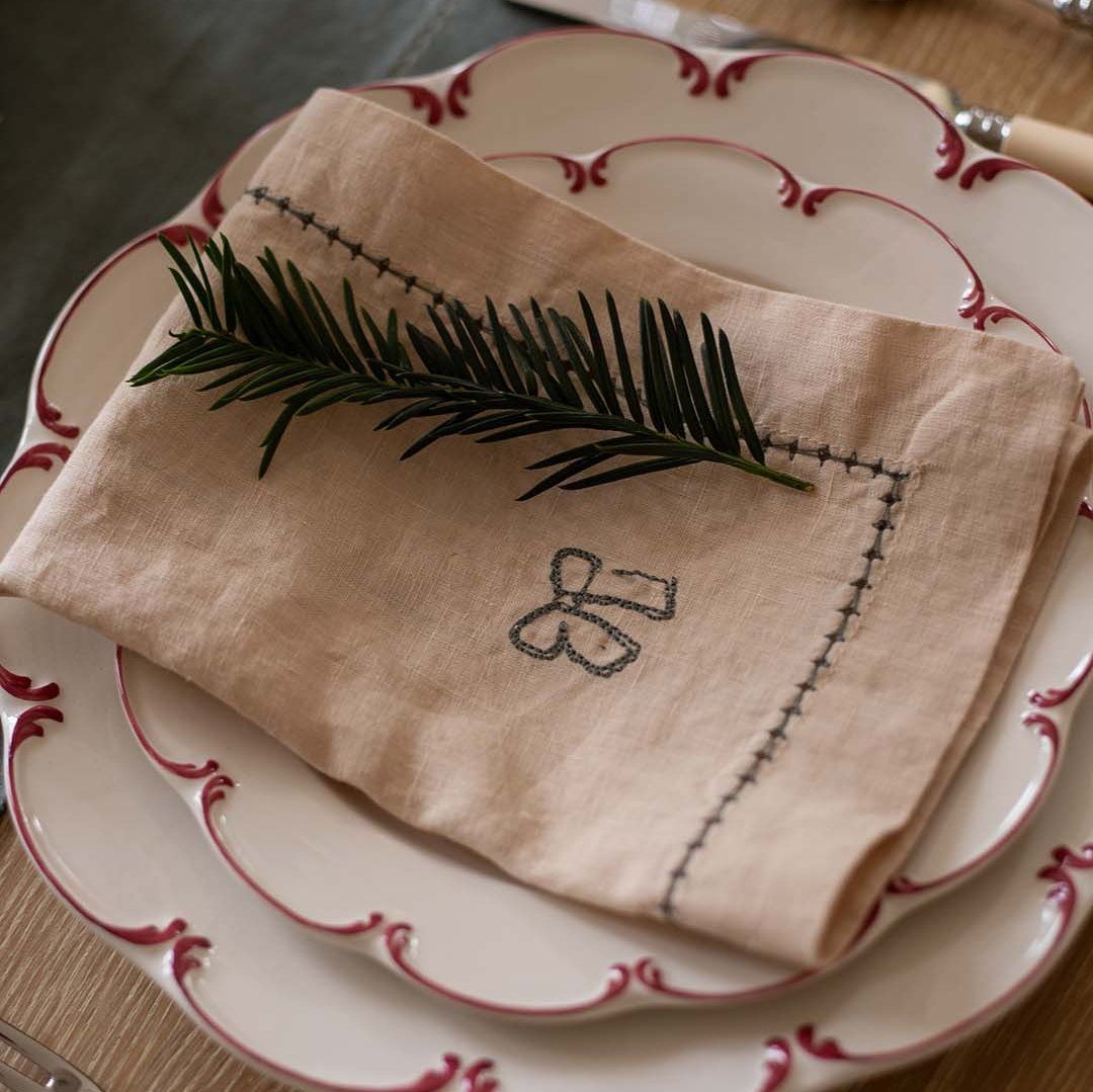 Embroidered Linen Bow Napkins Rustic linen napkin with embroidered bow and stitched trim—adds charm to Christmas place settings.
