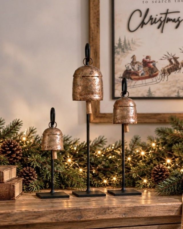 Add some festive vintage décor this season with these aged copper cowbells on iron stands