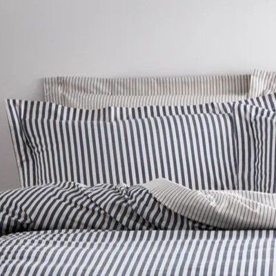 Add an extra cosy layer on your bed with these navy and white striped pillowcases.