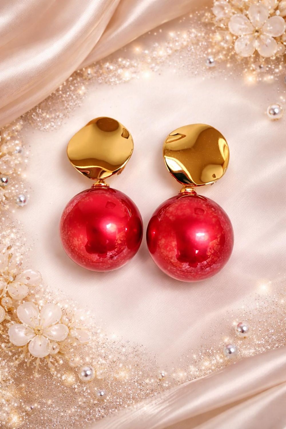 Red ball drop earrings with gold-tone tops