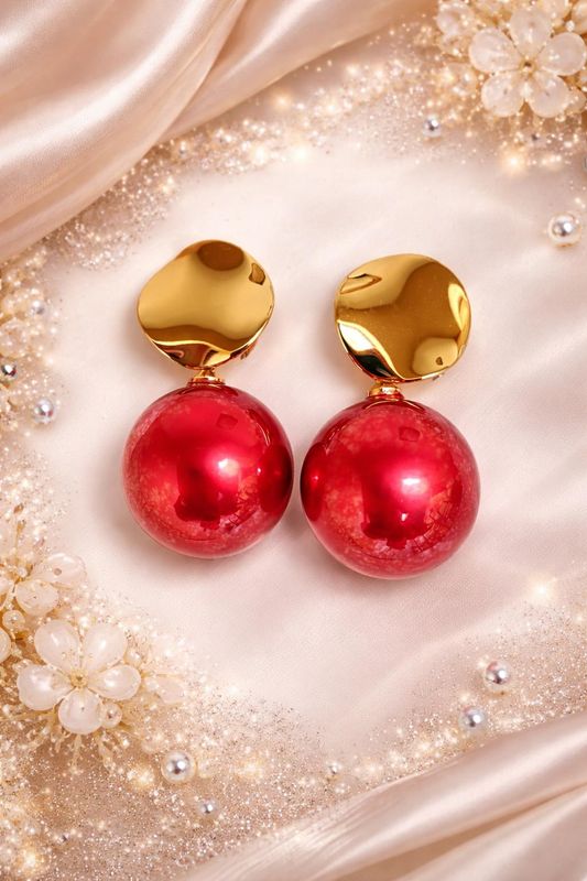 Red ball drop earrings with gold-tone tops