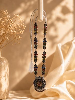 Long silver-tone temple-style necklace with floral and coin motifs