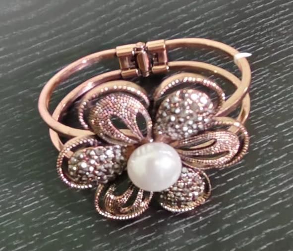 Rose-gold tone bracelet with butterfly/flower motif and pearl centre