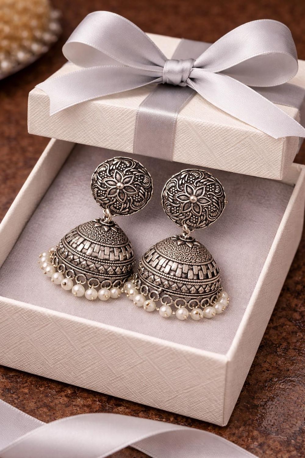 Silver-tone jhumka earrings with white pearl beading
