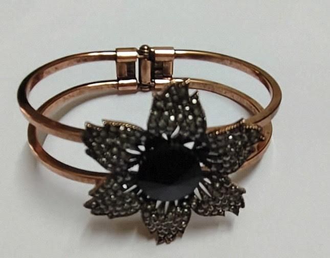 Gold-tone bangle with black flower