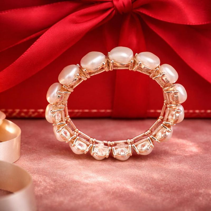 Gold tone bangle with square white beads