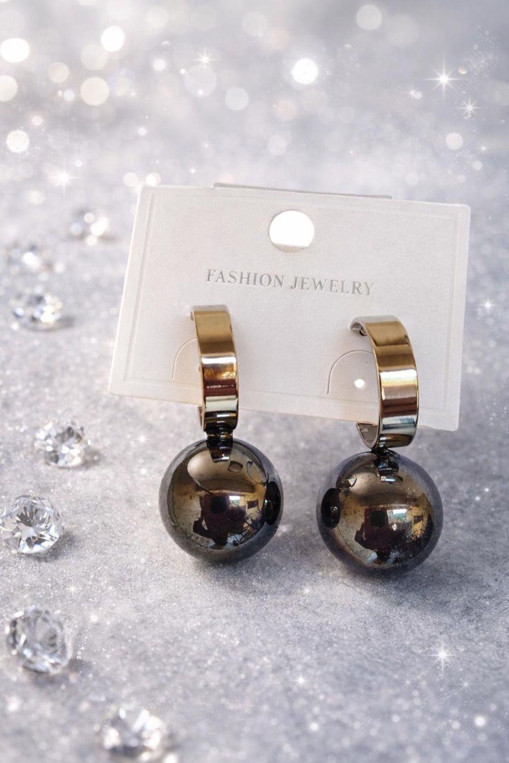 Black spherical drop earrings with silver-tone backing