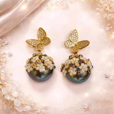 Gold-tone butterfly stud earrings with pearl-cluster drops