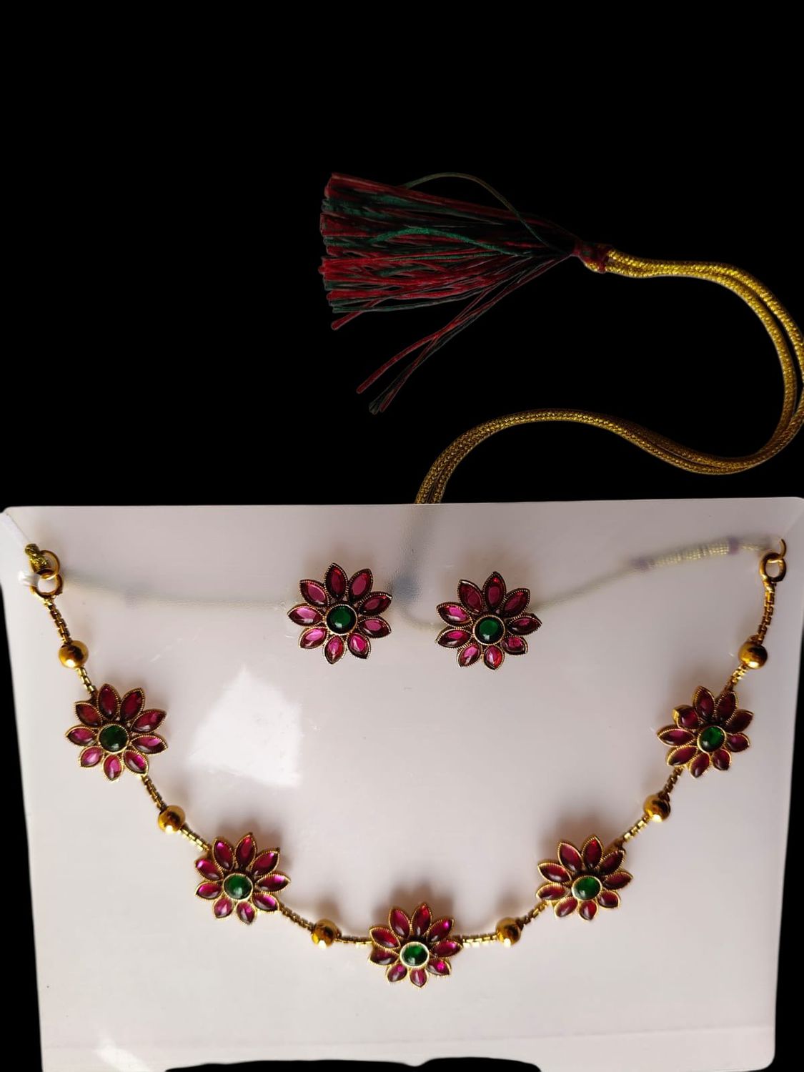 Gold-tone necklace set with pink and green flower charms and matching earrings