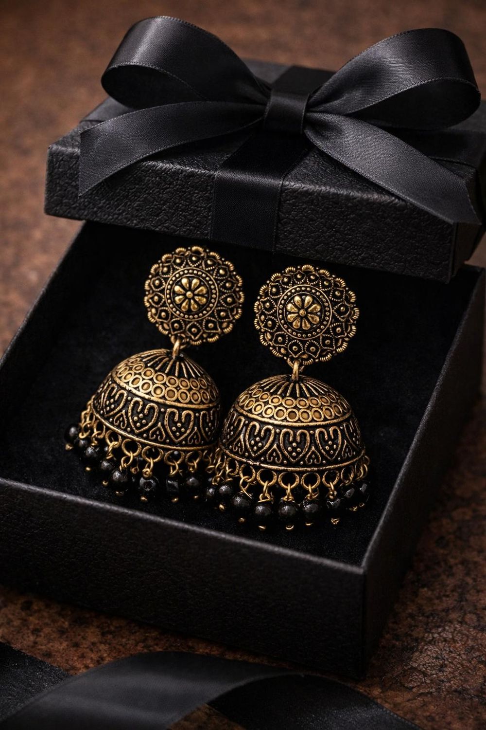 Silver tone  jhumka earrings with circular filigree design with black beads