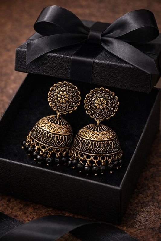 Silver tone  jhumka earrings with circular filigree design with black beads
