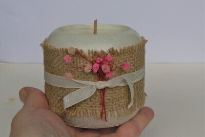 Small candle in concrete pot