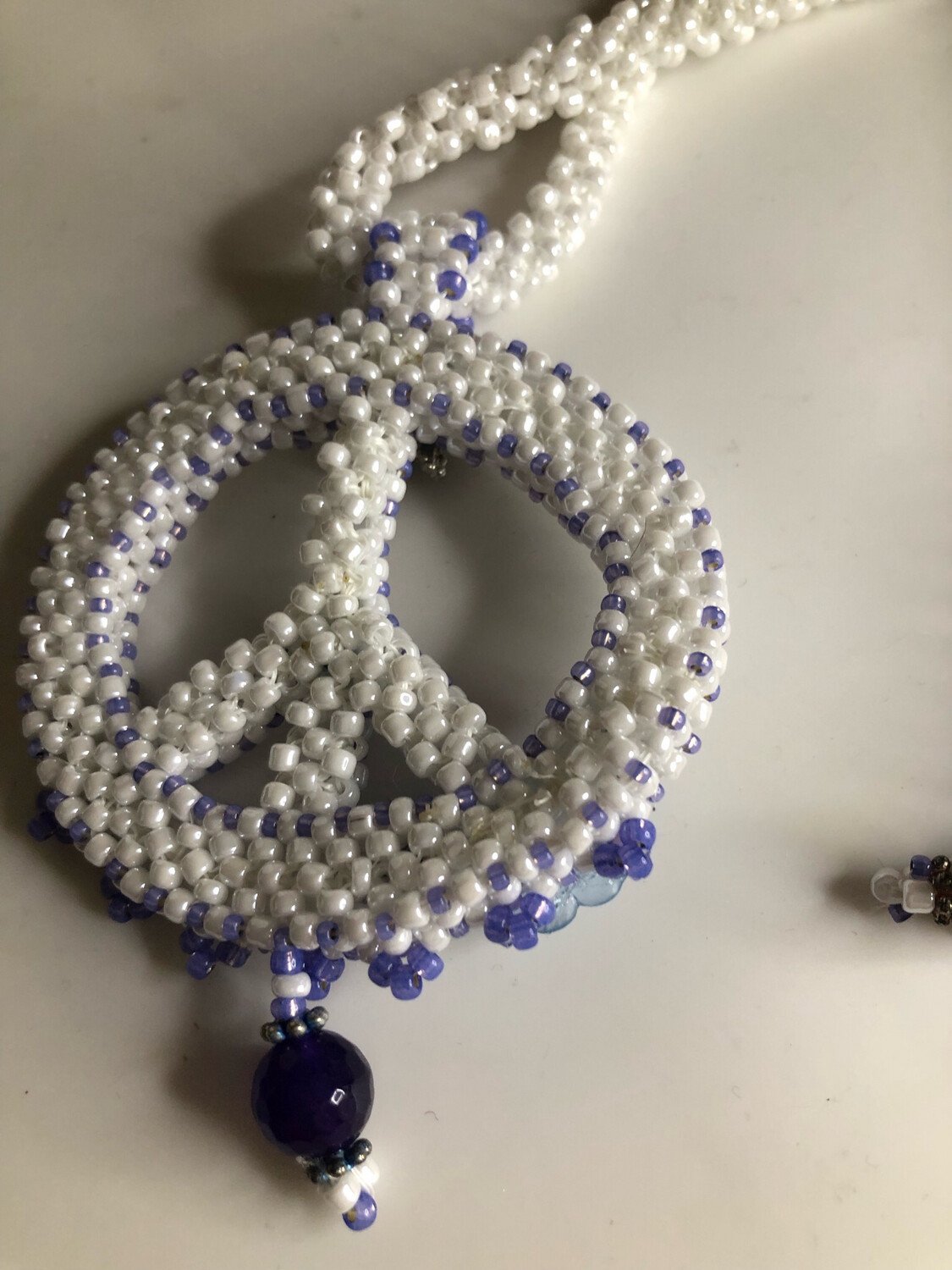 White Beaded Peace Sign with Blue and purple Accents