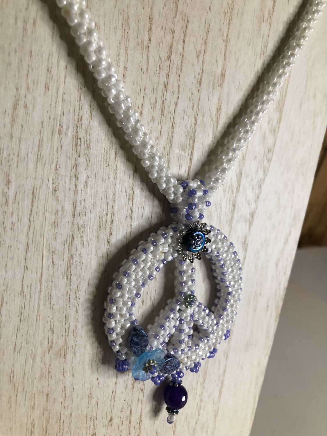 White Beaded Peace Sign with Blue and purple Accents