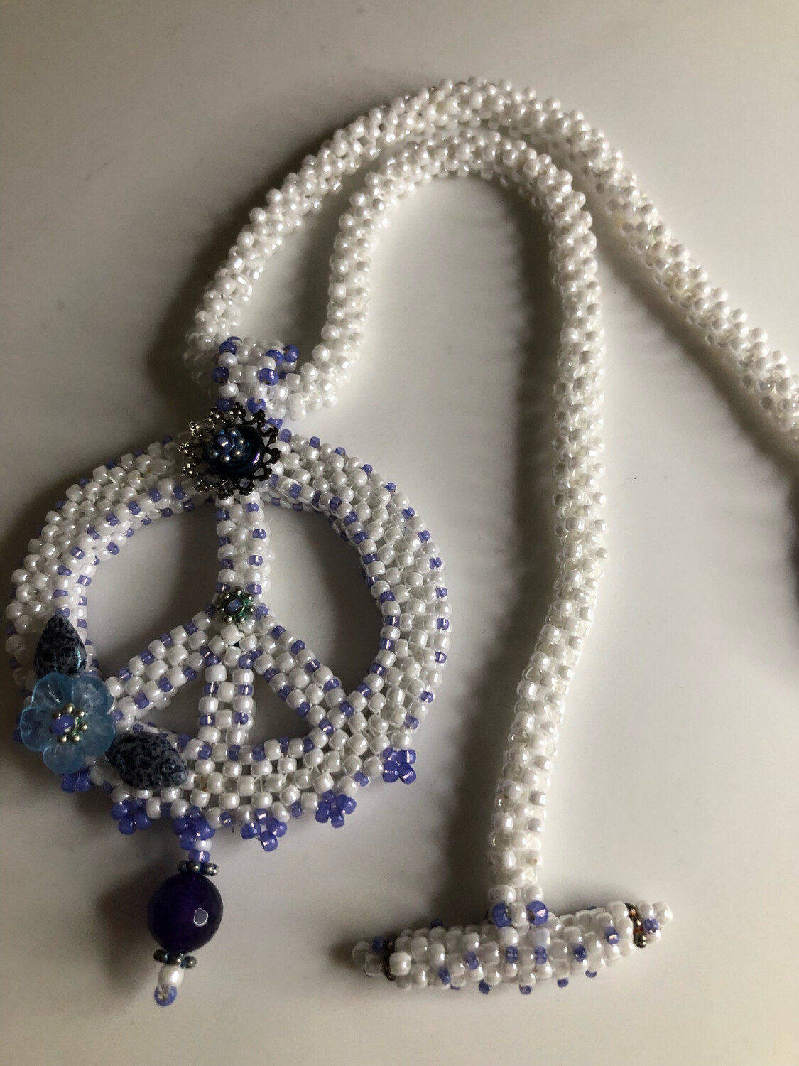 White Beaded Peace Sign with Blue and purple Accents