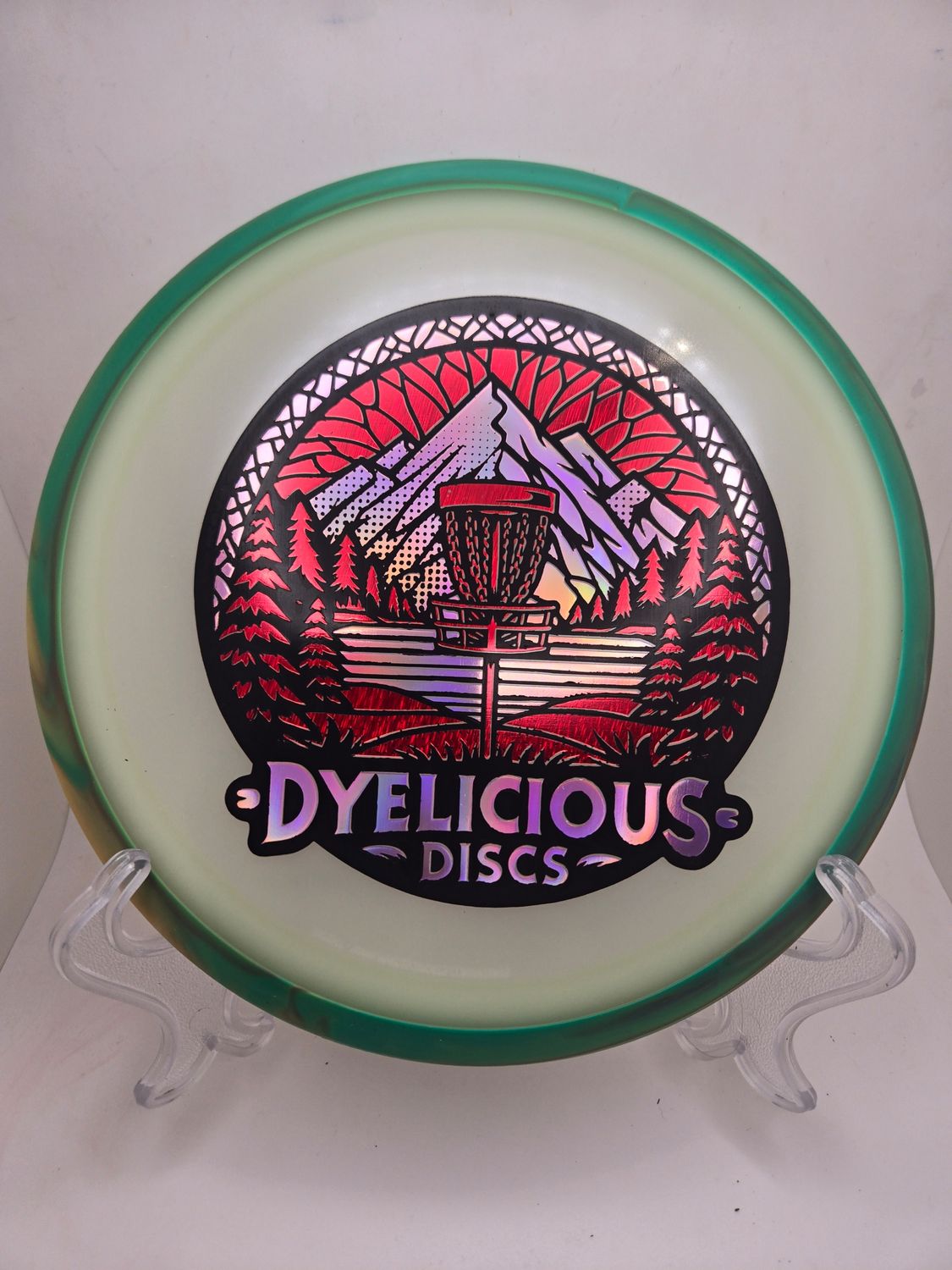 Axiom Discs Virus - Eclipse Green with Green/Orange Swirly Rim Triple Foil 1 of 1 Dyelicious Discs Stamp with Red Streak background and Pink stamp 174g