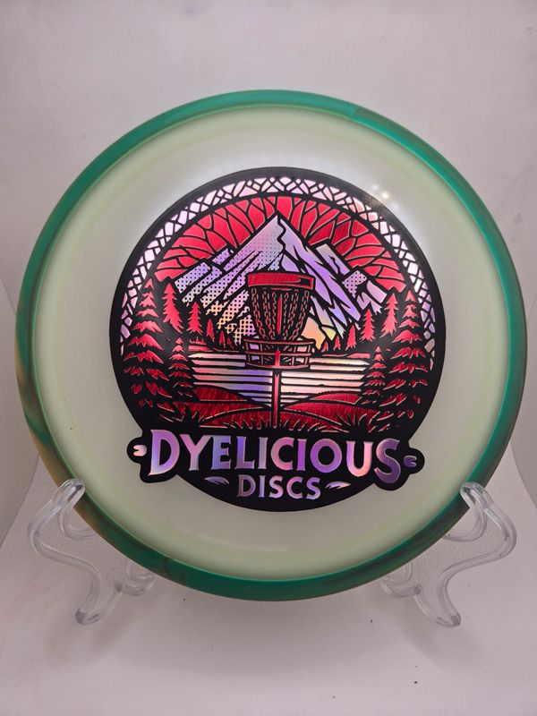 Axiom Discs Virus - Eclipse Green with Green/Orange Swirly Rim Triple Foil 1 of 1 Dyelicious Discs Stamp with Red Streak background and Pink stamp 174g