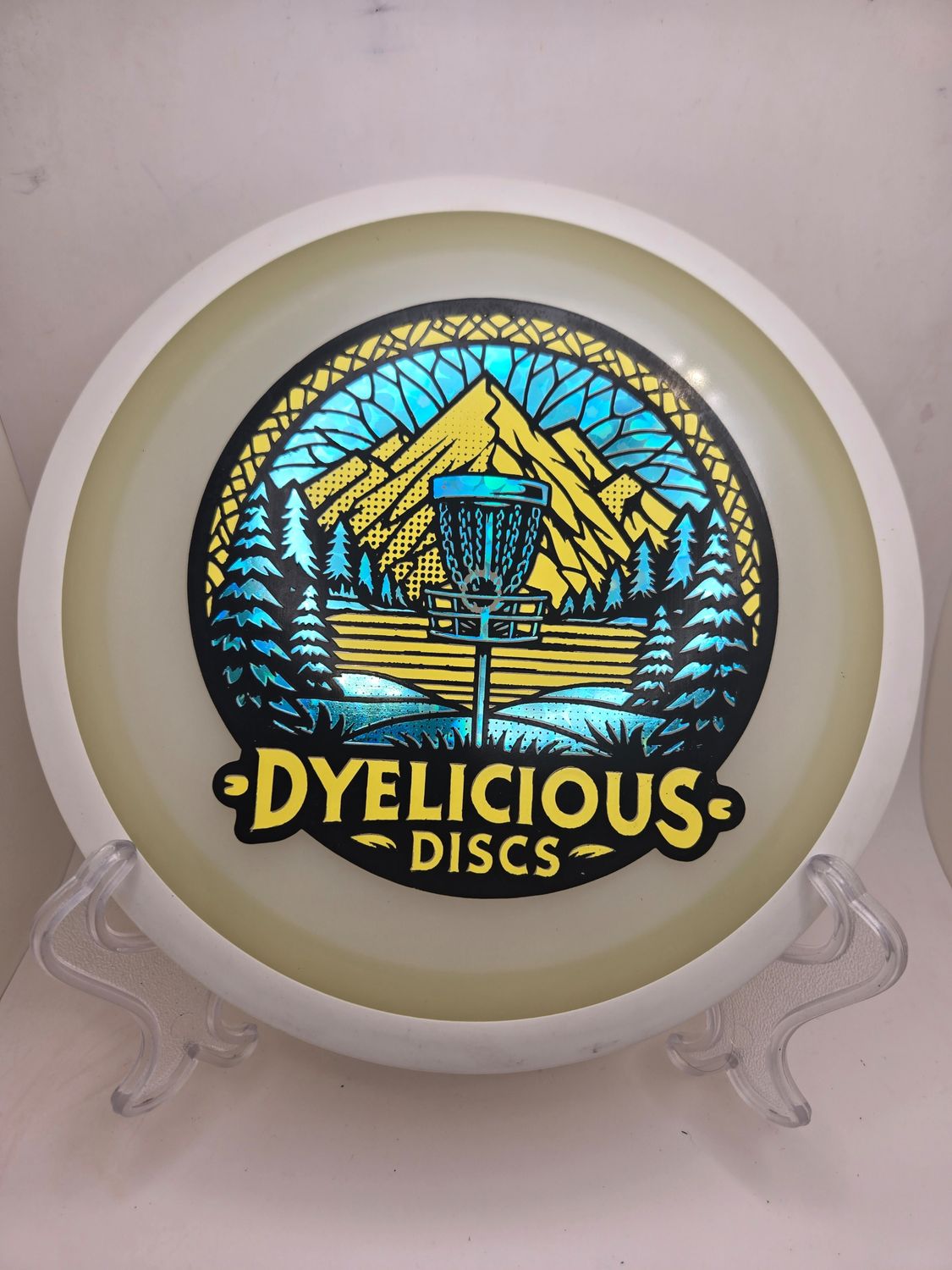 MVP Discs Eclipse Green Orbital Triple Foil 1 of 1 Dyelicious Discs Stamp with Blue Flower background with Yellow 175g