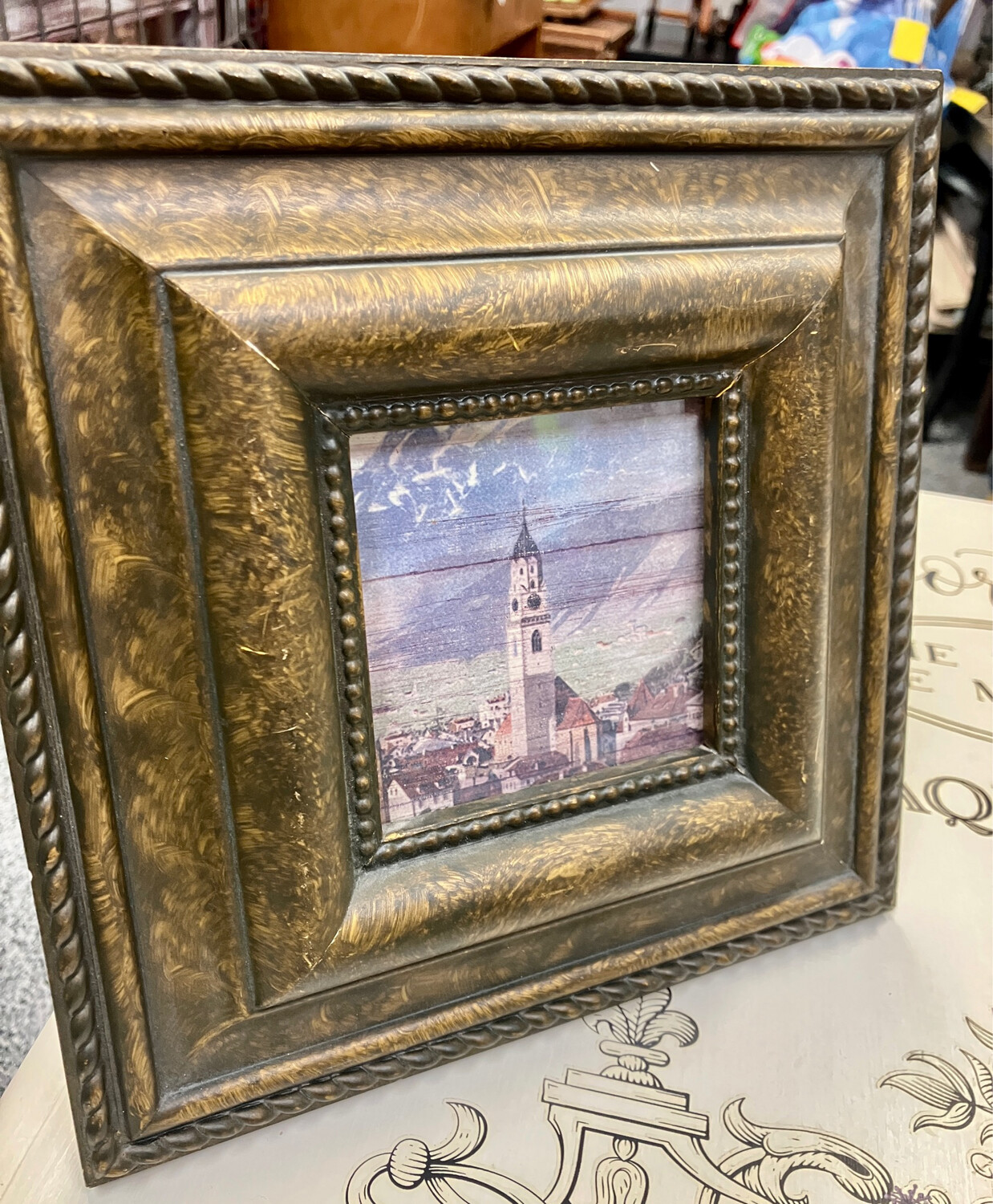 Square frame with church, town and mountains