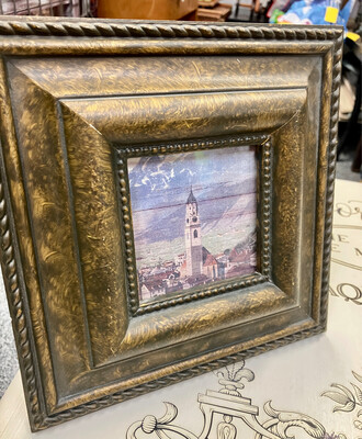 Square frame with church, town and mountains