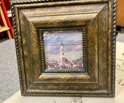 Square frame with church, town and mountains