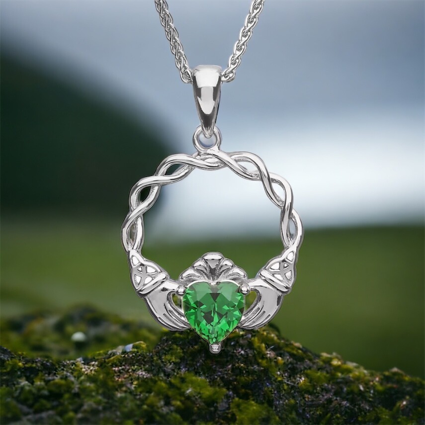 Sterling silver green stone claddagh pendant on moss