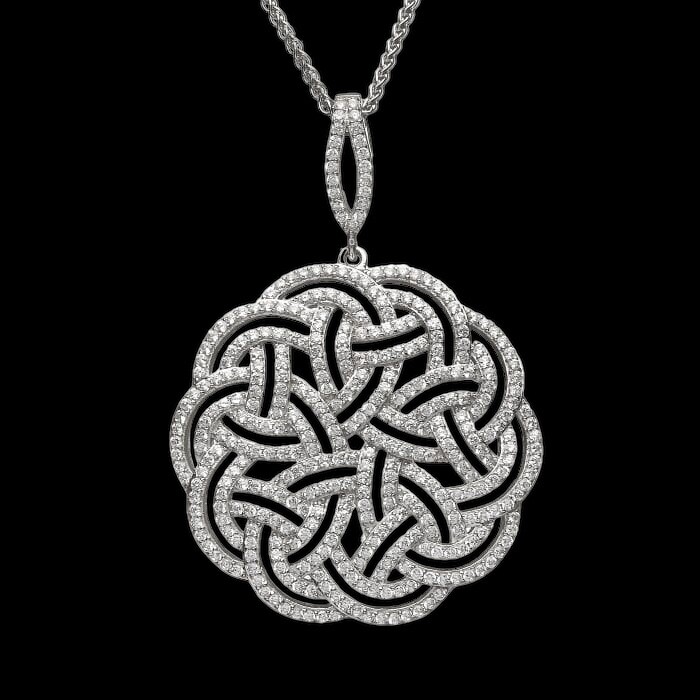 Interlaced Celtic Pattern Pendant Sterling silver interlaced Celtic Knot pendant with sparkling CZ stones, statement heritage jewelry, on black background.