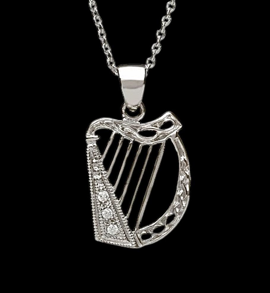 Delicate Harp with CZ Stones Celtic harp sterling silver pendant with CZ stones, traditional Irish jewelry and cultural symbol, shown on black background.