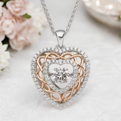 Celtic heart necklace in sterling silver with rose gold knotwork and central cubic zirconia, perfect gift for anniversaries.