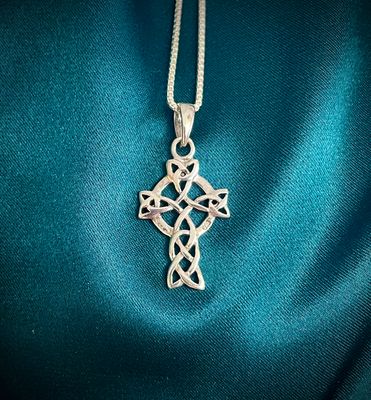 Sterling silver Celtic cross pendant with trinity knots, detailed Celtic knot design, meaningful heritage jewelry. 