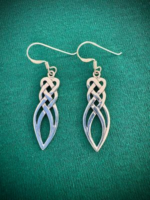 Sterling Silver Celtic Knot Drop Earrings on Green Fabric.