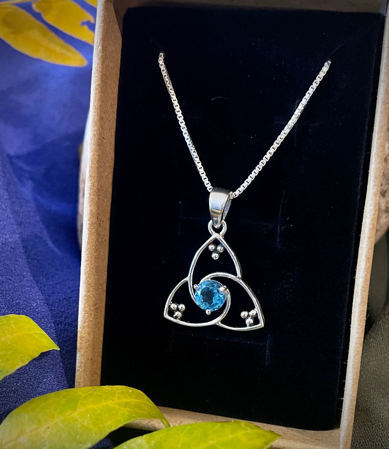 Blue Sapphire Trinity Knot Celtic Trinity Knot necklace in sterling silver with blue sapphire gemstone, perfect for September birthdays.