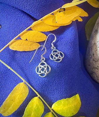 Celtic Knot Earrings - Beth Elegant sterling silver earrings with classic Celtic knot pattern, representing love, loyalty, and eternity. On purple fabric
