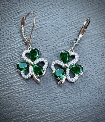 Sterling Silver and Cubic Zirconia Irish Shamrock Earrings with Lever Backs on Grey Background. 