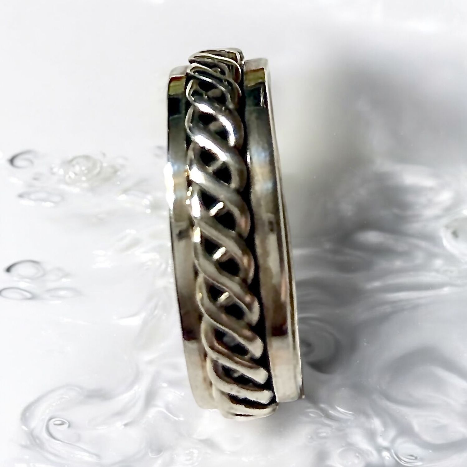 Celtic weave spinner ring in sterling silver, unisex design, symbolizing unity and Celtic heritage.