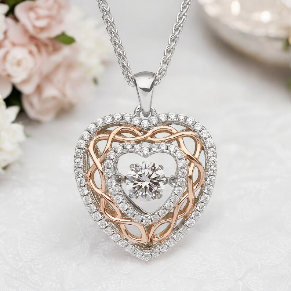 Celtic heart necklace in sterling silver with rose gold knotwork and central cubic zirconia, perfect gift for anniversaries.