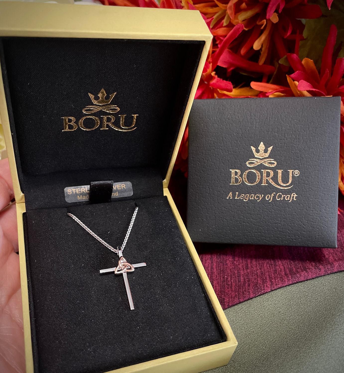 Celtic cross necklace in sterling silver featuring a rose gold plated Trinity knot centerpiece. Made in Ireland by Boru.
