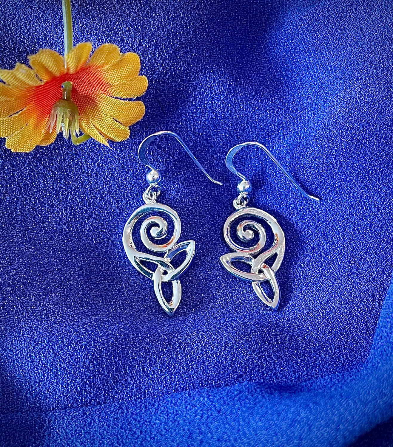 Sterling Silver Celtic Swirl Drop Earrings on Blue Background