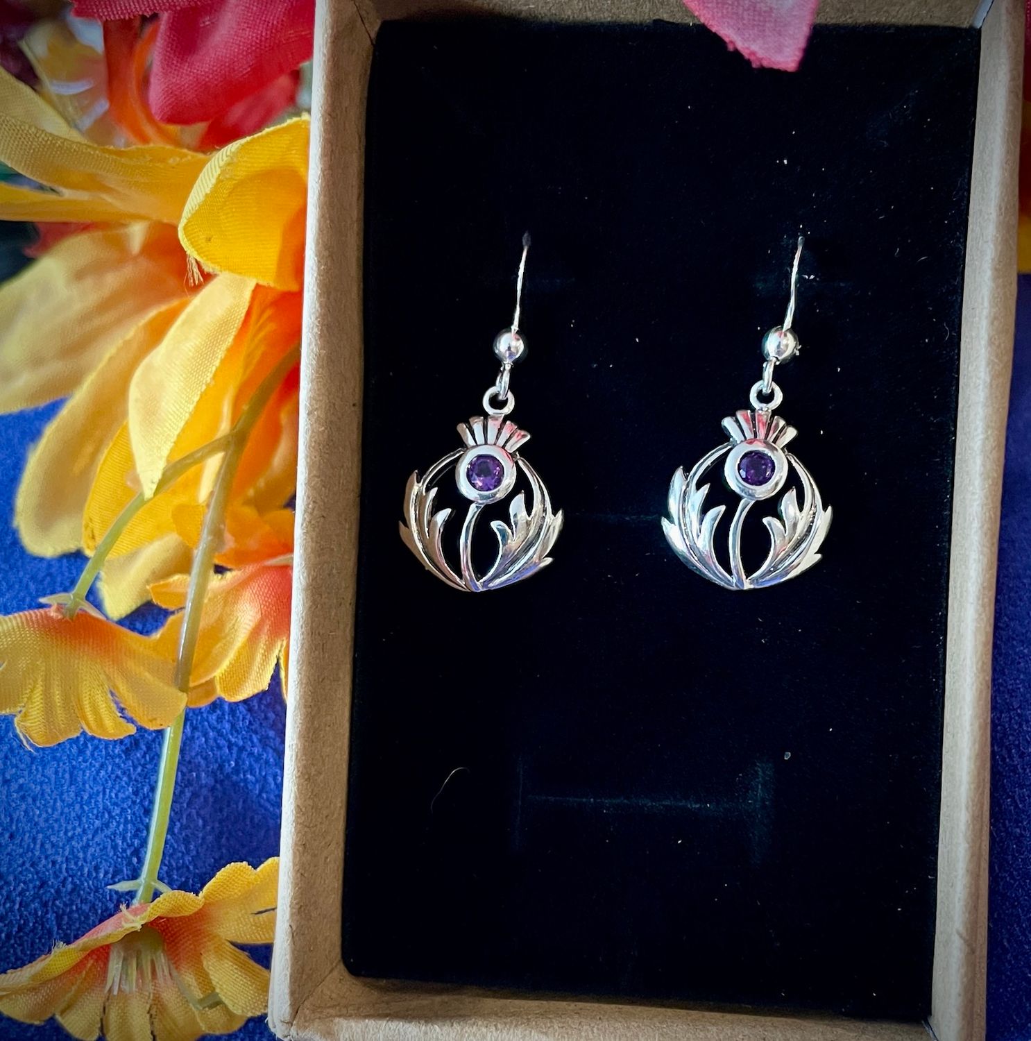Celtic-inspired sterling silver thistle earrings featuring amethyst-colored cubic zirconia, perfect Scottish culture jewelry.