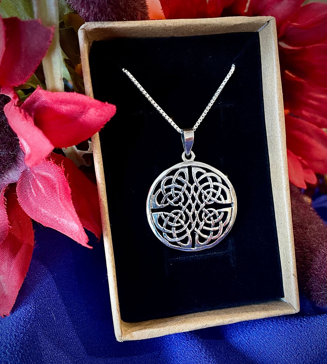 Sterling silver Celtic Knot pendant necklace, elegant jewelry symbolizing eternal Celtic love and heritage, in jewelry box.