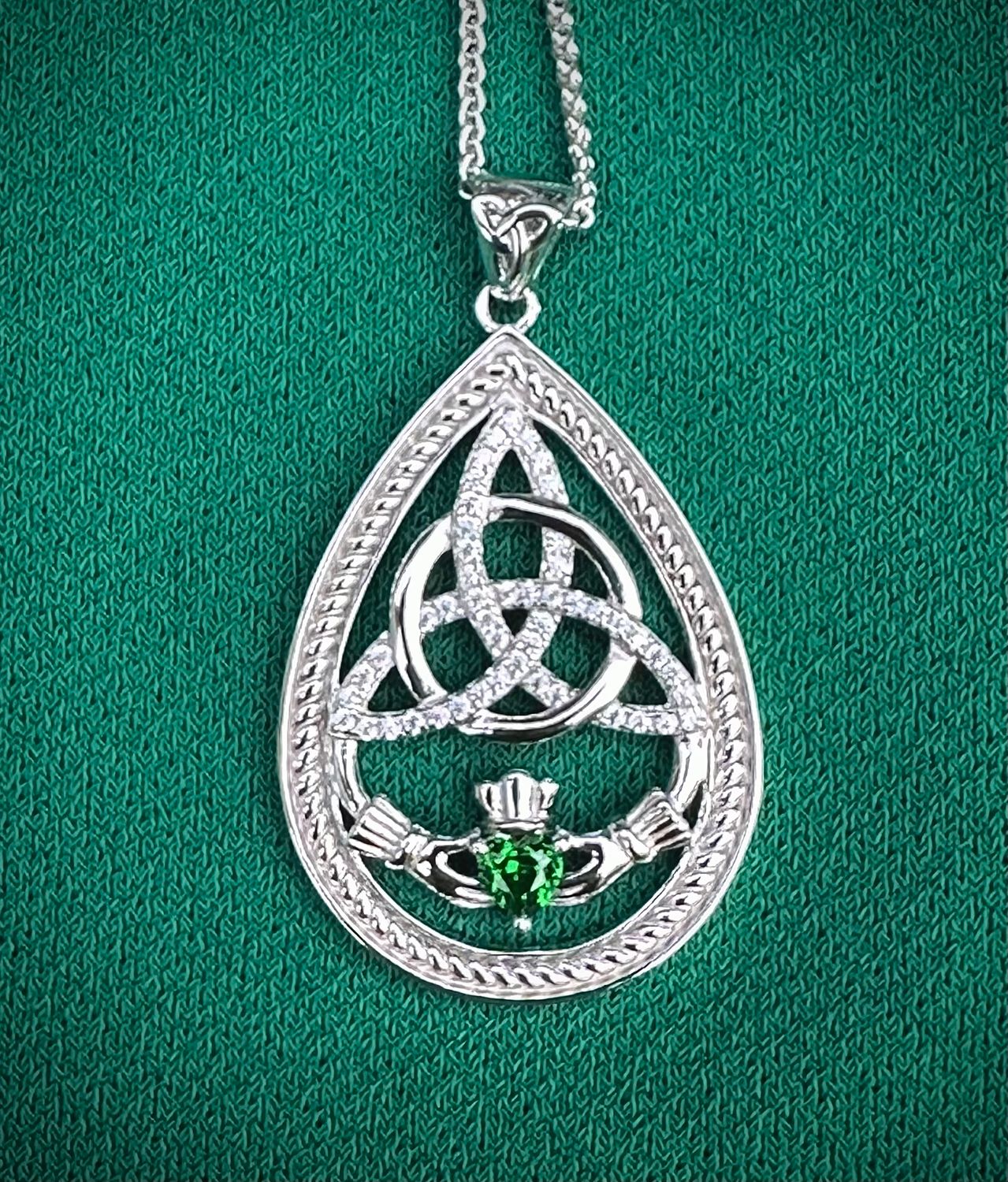 Luxury sterling silver pendant featuring a Claddagh design with intertwined Trinity Knot, symbolizing love and loyalty. 