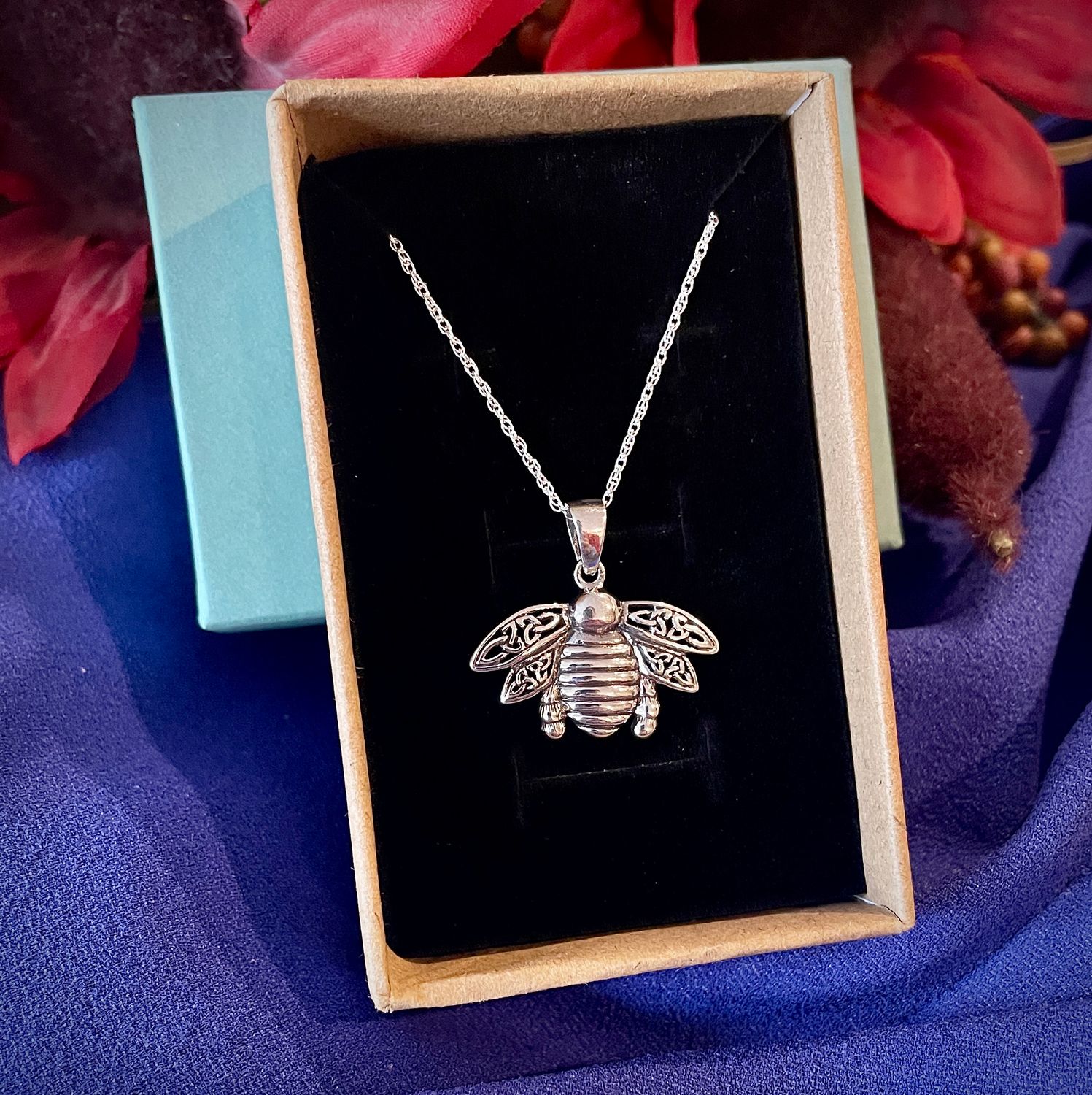 Sterling silver Outlander-inspired bee pendant, Celtic heritage jewelry for fans, shown in jewelry box. 