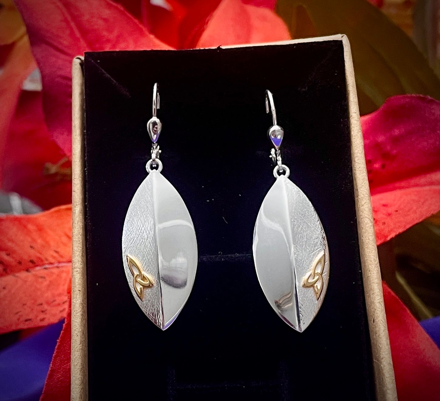 Elegant sterling silver earrings in the shape of a shield, accented with a raised Celtic Trinity Knot. In jewelry box.