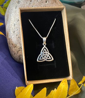 Silver Triquetra Pendant Sterling silver Celtic triquetra pendant necklace with intricate three-loop knot design, shown in jewelry box.