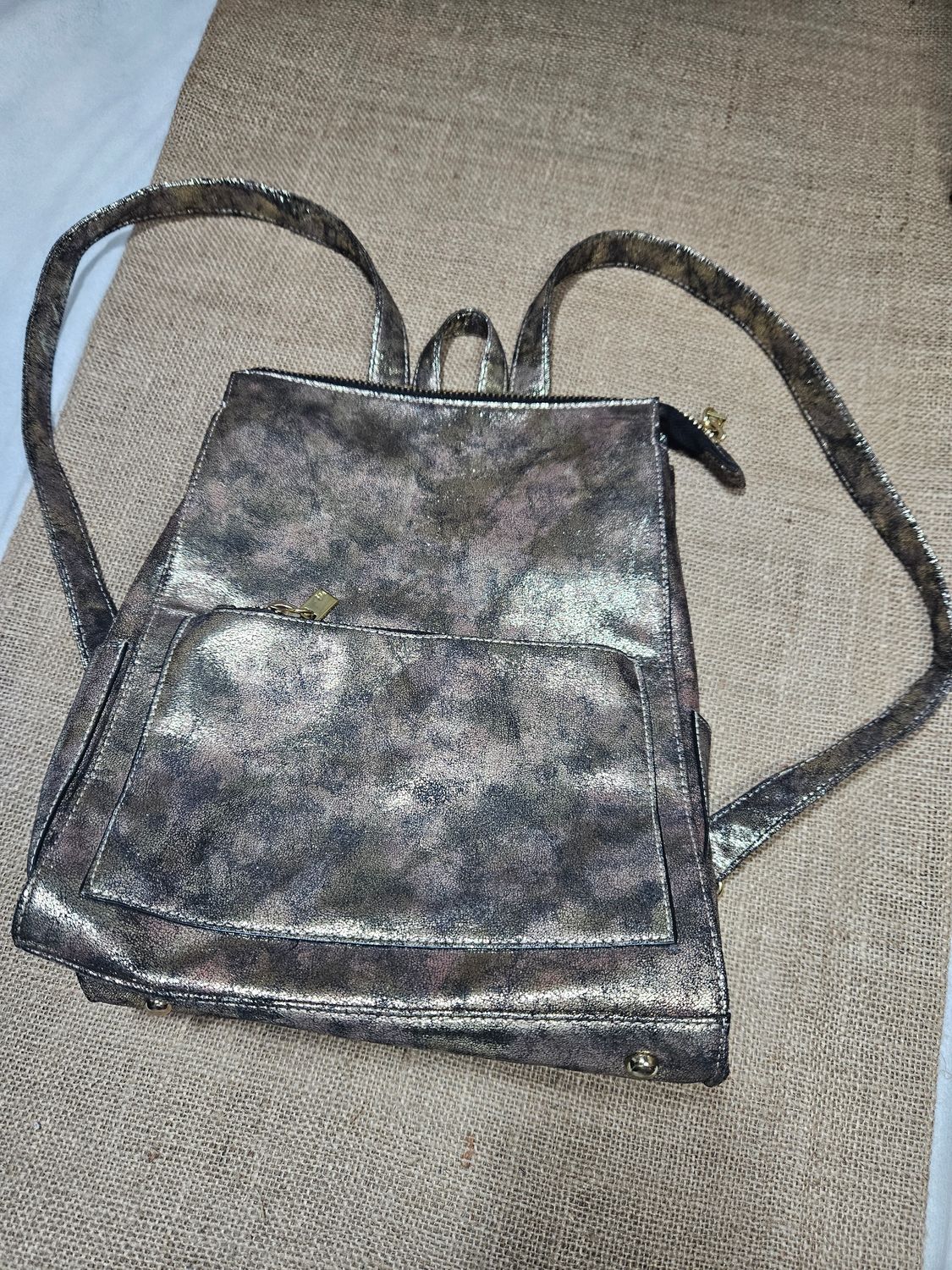MOCHILA, EN SIMIL CUERO CON BRILLO DORADO. VARIOS CIERRES. IMPECABLE IGUAL A NUEVO