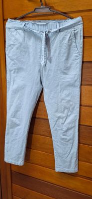 PANTALON DE TELA ELASTIZADA, CON PRETINA CON ELASTICO Y LAZO. BOLSILLOS. COLOR CELESTE. MARCA MINOT, TALLE M