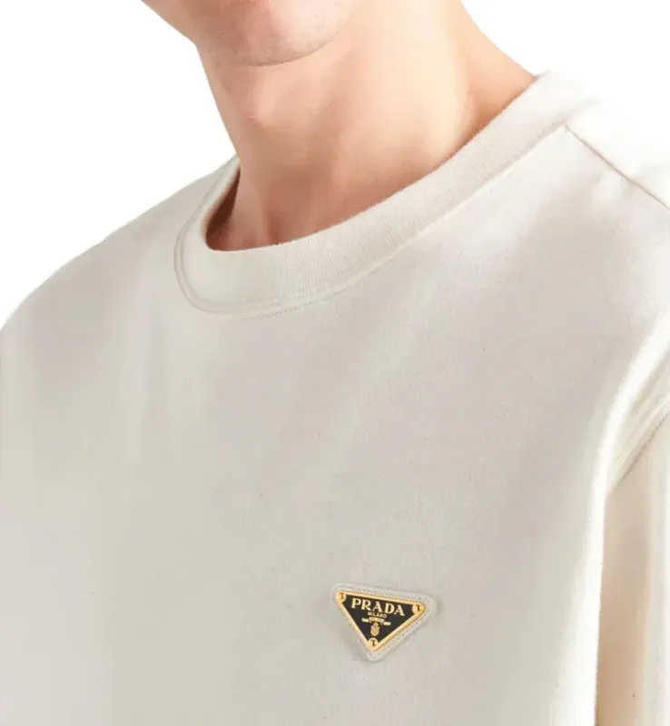 Close-up white Prada triangle logo t-shirt on model luxury cotton men detail