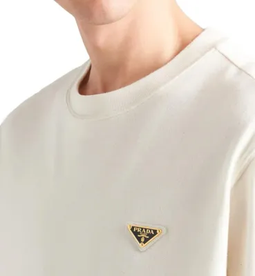 Close-up white Prada triangle logo t-shirt on model luxury cotton men detail